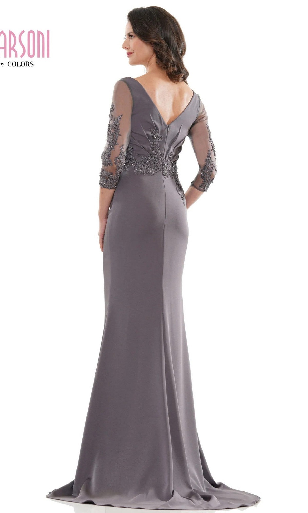 A woman models the Marsoni MV1145 long formal dress in mauve, featuring a fitted silhouette, sheer beaded sleeves, and a V-shaped back, while posing with her back to the camera.